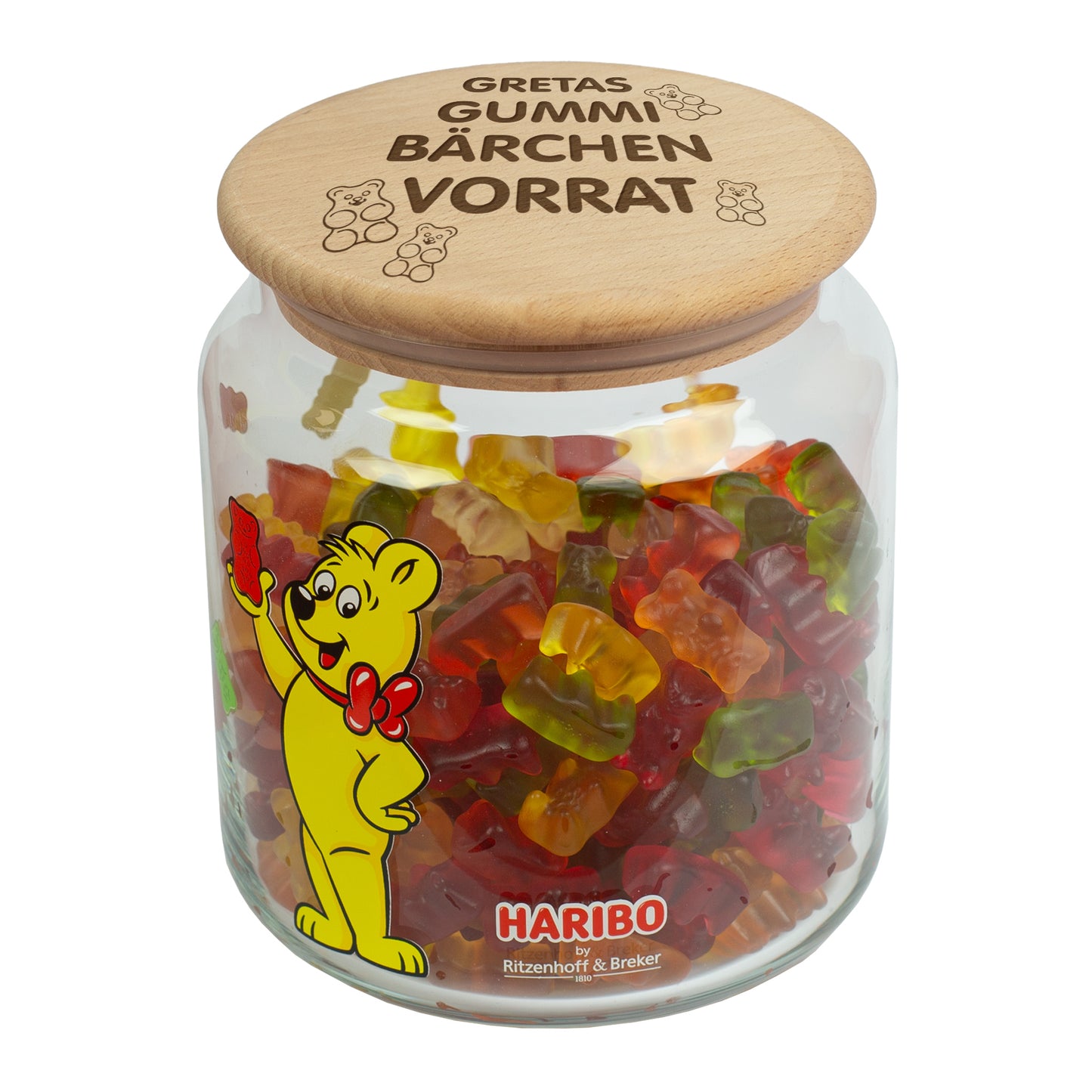 Freigestelltes HARIBO Glas mit personalisiertem Gravurdeckel und Goldbär-Motiv.