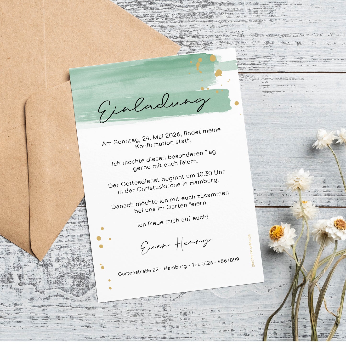 Einladungskarte zur Konfirmation mit modernem Aquarell-Design in Grün und goldenen Sprenkeln. Die Karte ist personalisiert mit Wunschtext und Namen. Sie liegt auf einer rustikalen Holzoberfläche, begleitet von einem braunen Umschlag und zarten Trockenblumen.