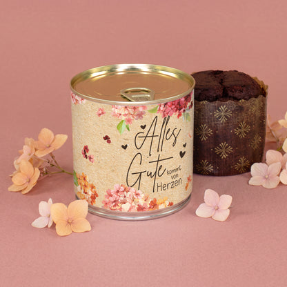 Brownie Kuchen in der Dose mit floralem Alles Gute Motiv und Blütendekoration auf rosa Hintergrund