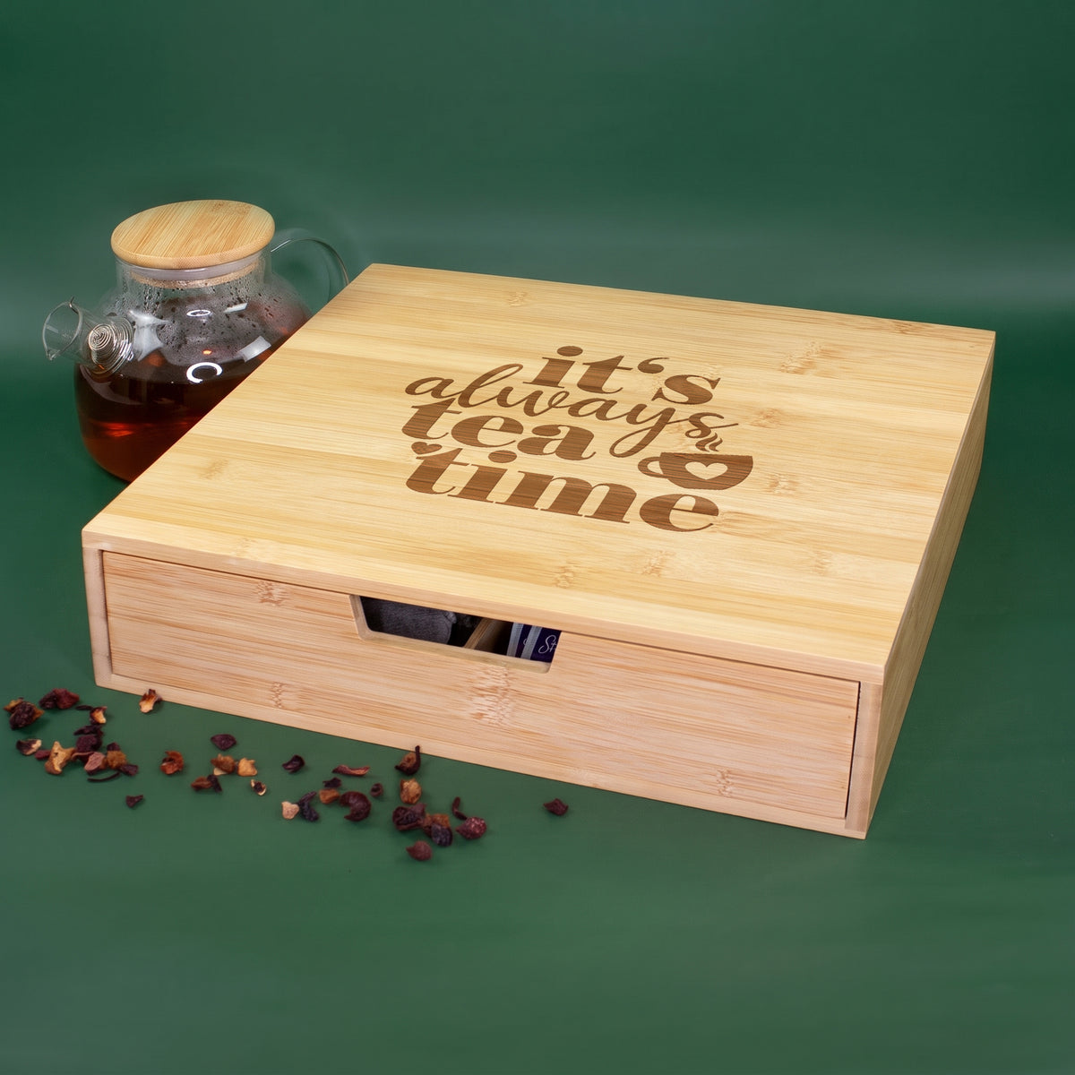Teebox aus Bambus mit Schublade und It's always tea time Motiv neben einer Teekanne