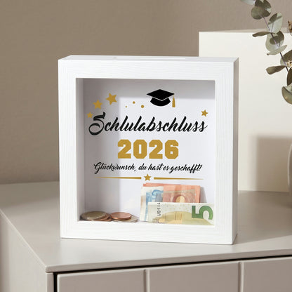 Bilderrahmen-Spardose „Schulabschluss 2026“ mit Geldscheinen und Münzen als Abschlussgeschenk