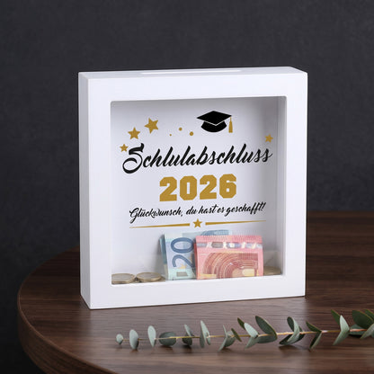 Bilderrahmen-Spardose „Schulabschluss 2026“ mit Geldscheinen und Münzen als Abschlussgeschenk