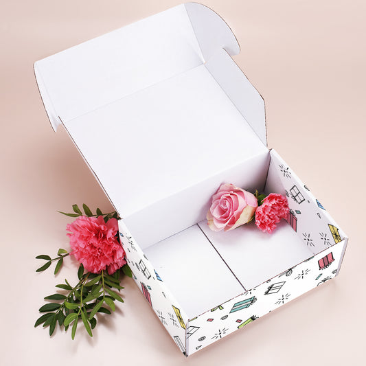 Geschenkbox mittelgroß mit Motiv „Alles Gute“, geöffnet mit Blüten im Inneren