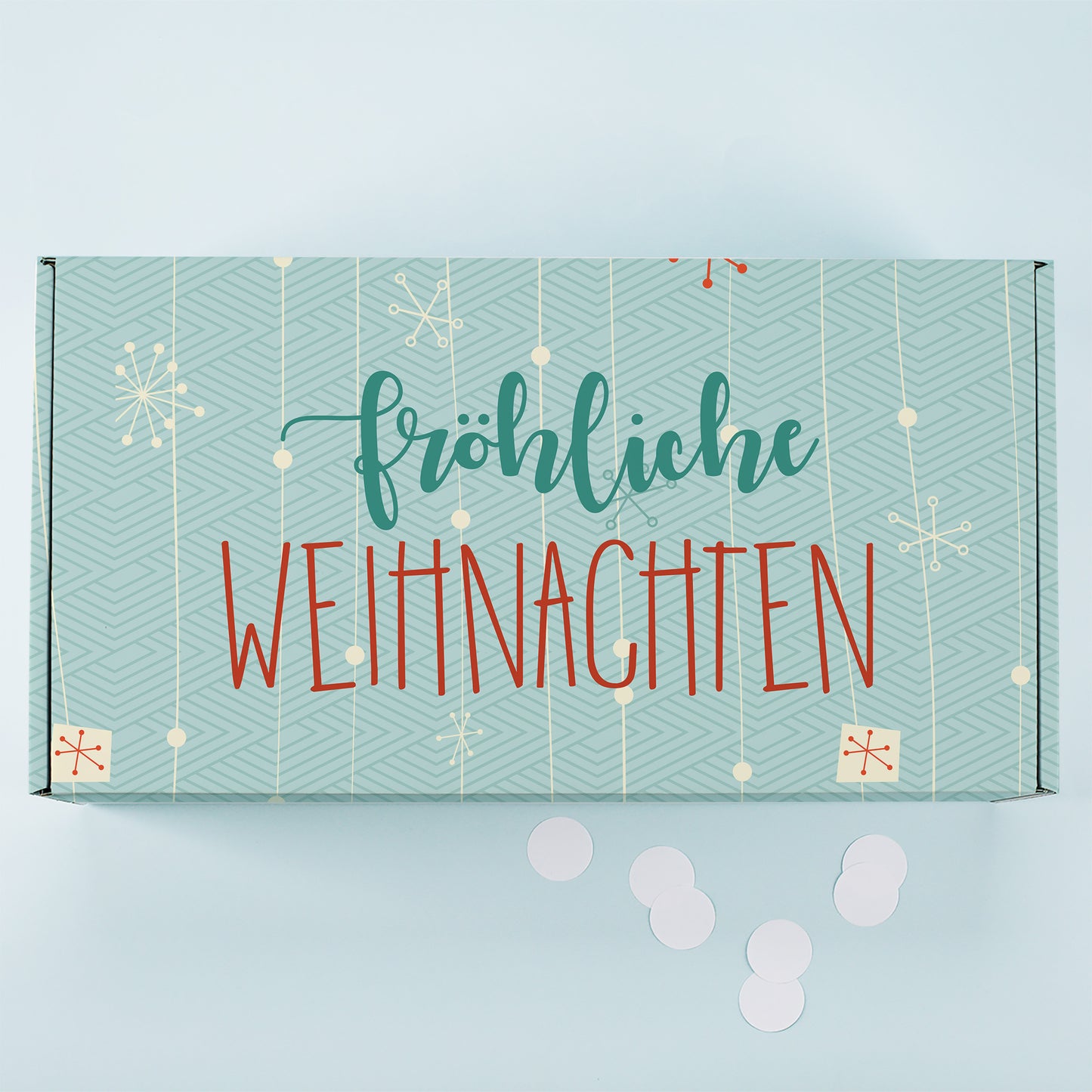 Türkise Weihnachtsbox von oben mit modernem Muster, hängenden Ornamenten und großem Fröhliche Weihnachten Schriftzug