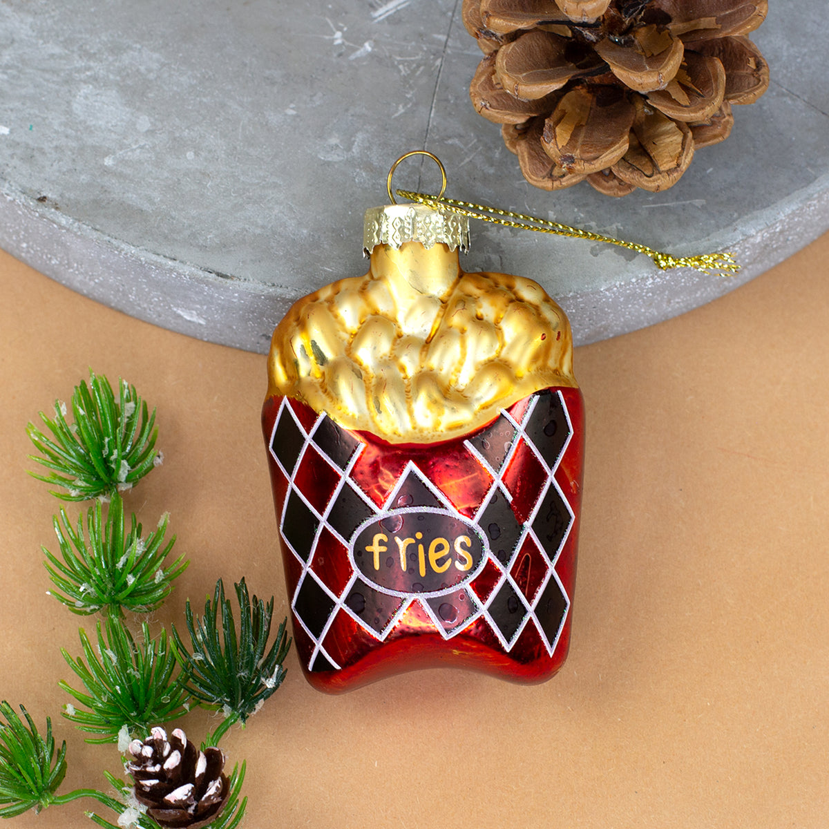 Pommes Weihnachtsbaumschmuck aus Glas in roter Verpackung mit goldgelben Fritten als Detailaufnahme