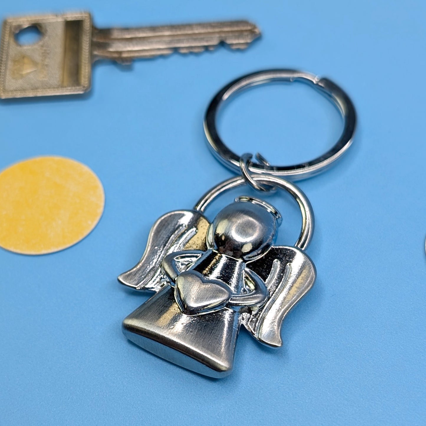 Detailaufnahme des Schlüsselanhängers Engel mit Herz, Fokus auf die Form und Struktur der Figur