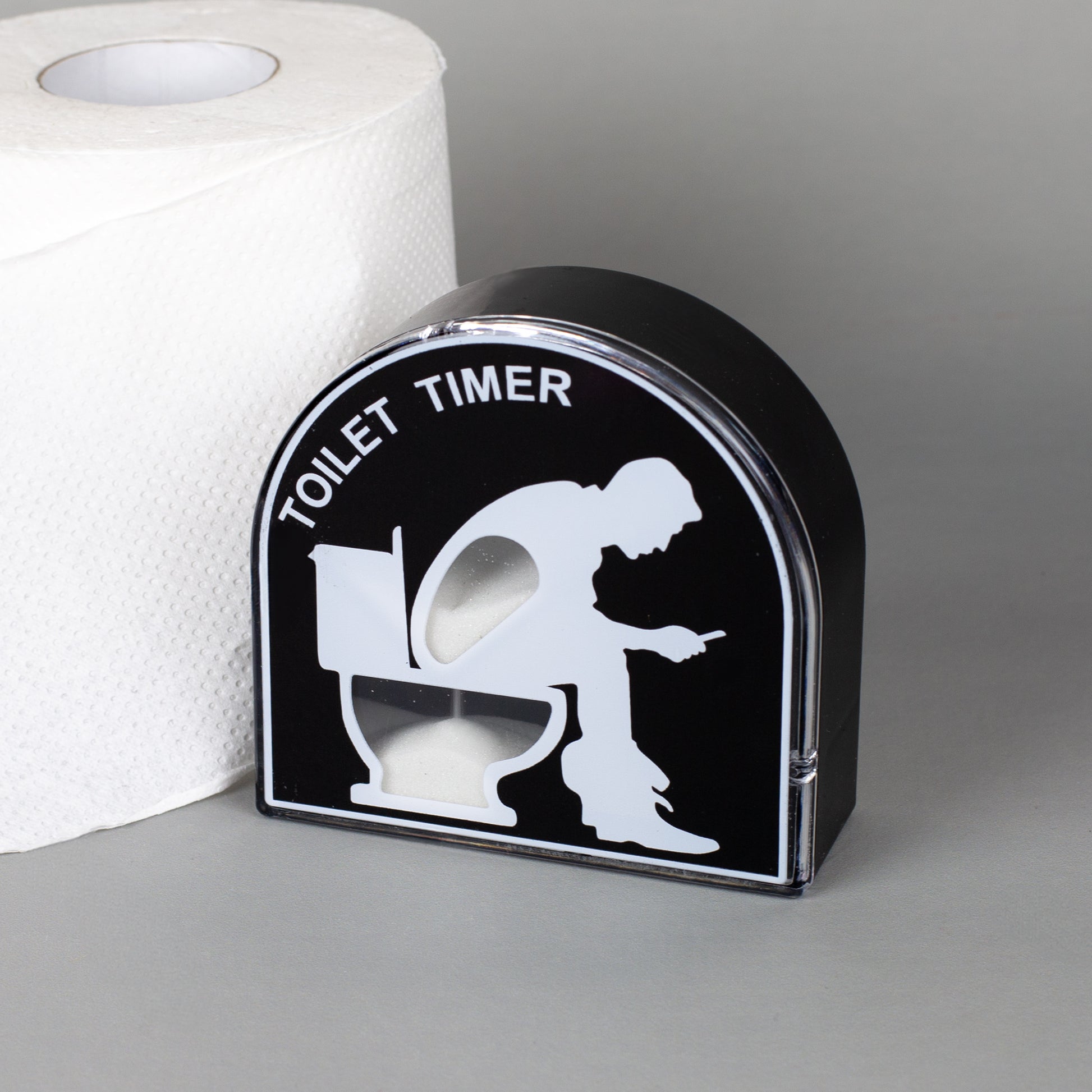 Lustiger Toilet Timer als Sanduhr mit schwarzem Design neben einer Toilettenpapierrolle