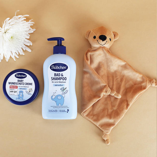 Kleiner Geschenkkorb mit Regenbogenmotiv zur Geburt in rosa oder blau - wahlweise gefüllt