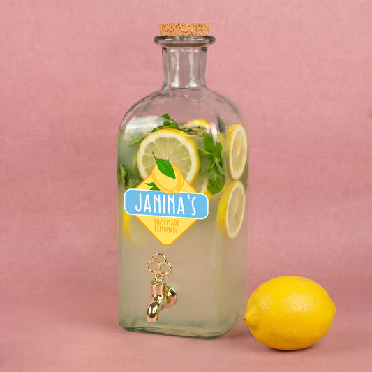 Personalisierter Glas Getränkespender mit Zitronen-Motiv, Name Janinas und gefüllter Limonade mit Zitronenscheiben und Minze