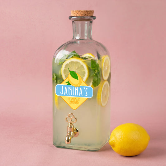 Personalisierter Glas Getränkespender mit Zitronen-Motiv, Name Janinas und gefüllter Limonade mit Zitronenscheiben und Minze
