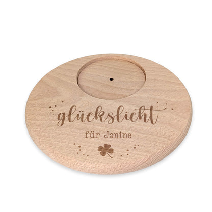 Freigestellter Holzuntersetzer mit Gravur „Glückslicht für Janine“ und Kleeblatt
