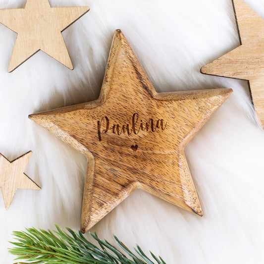 Personalisierter Holzstern mit Gravur „Paulina“ und Herzdetail auf weißem Felluntergrund mit kleinen Holzsternen