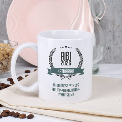 Glückwunsch-Tasse zum Abitur mit Name und Wunschtext dekoriert auf Serviette