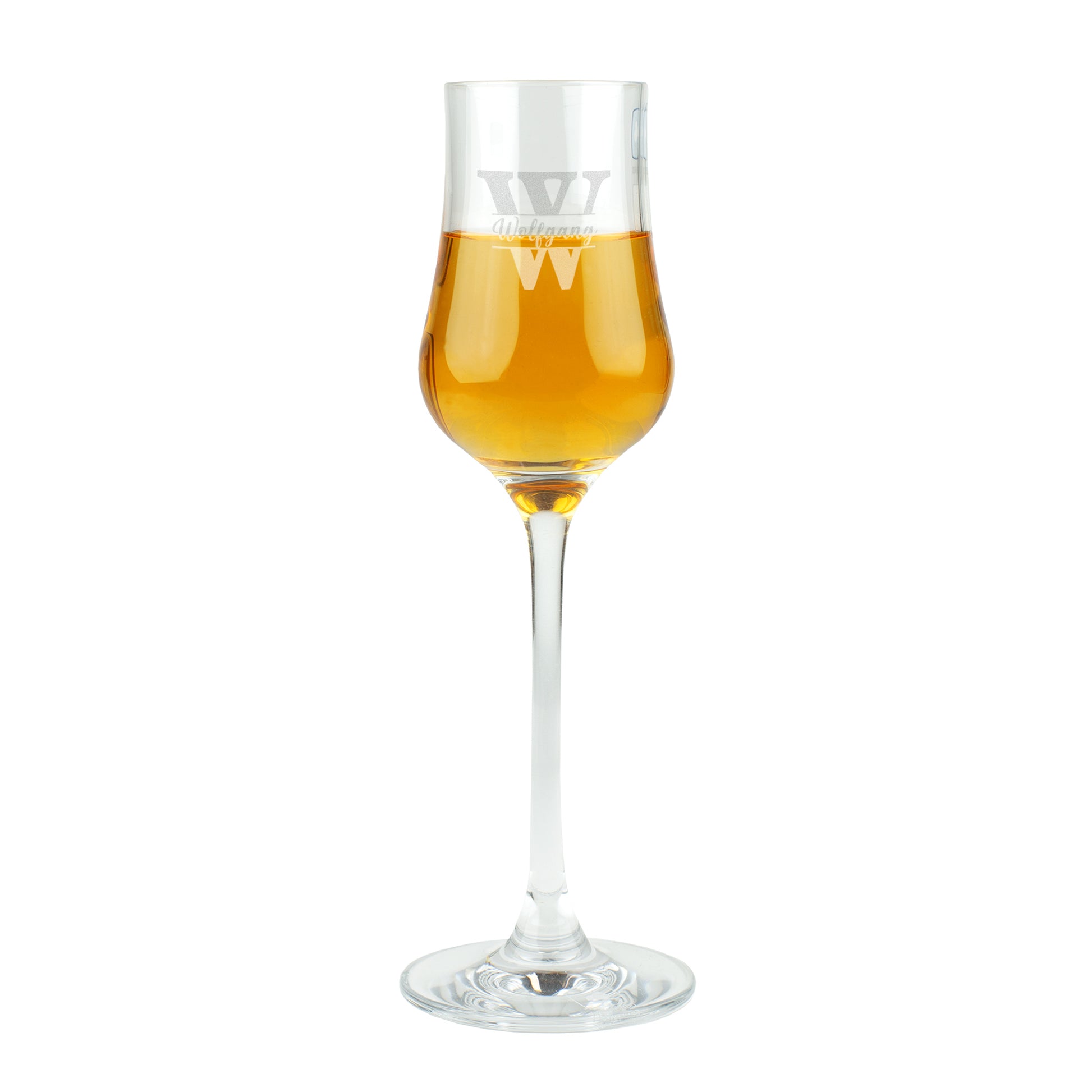 Freigestellte Studioaufnahme des Leonardo Grappaglases mit Gravur „Wolfgang“ und goldfarbenem Inhalt.