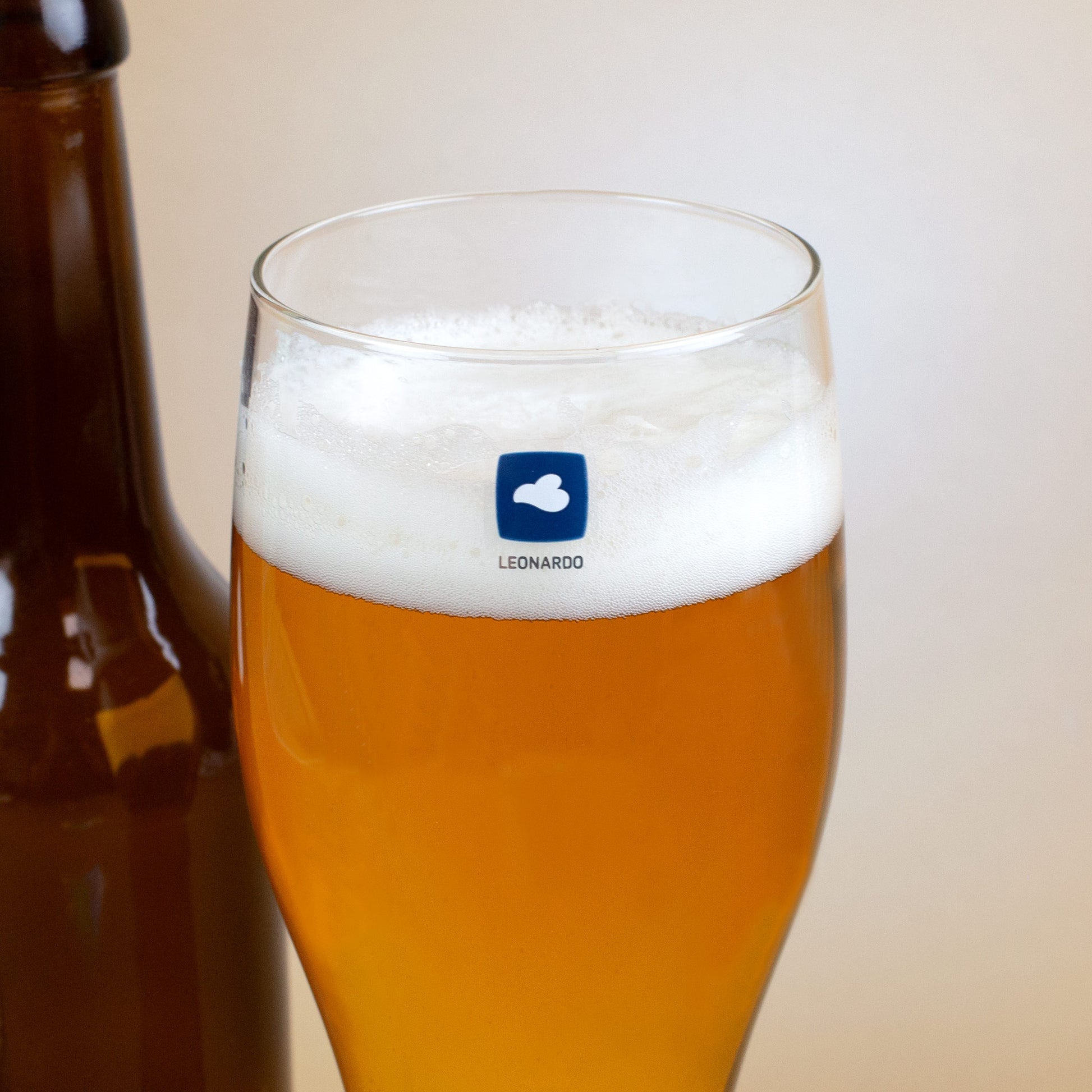 Detailaufnahme Weizenglas mit Leonardo-Logo, gefüllt mit Bier