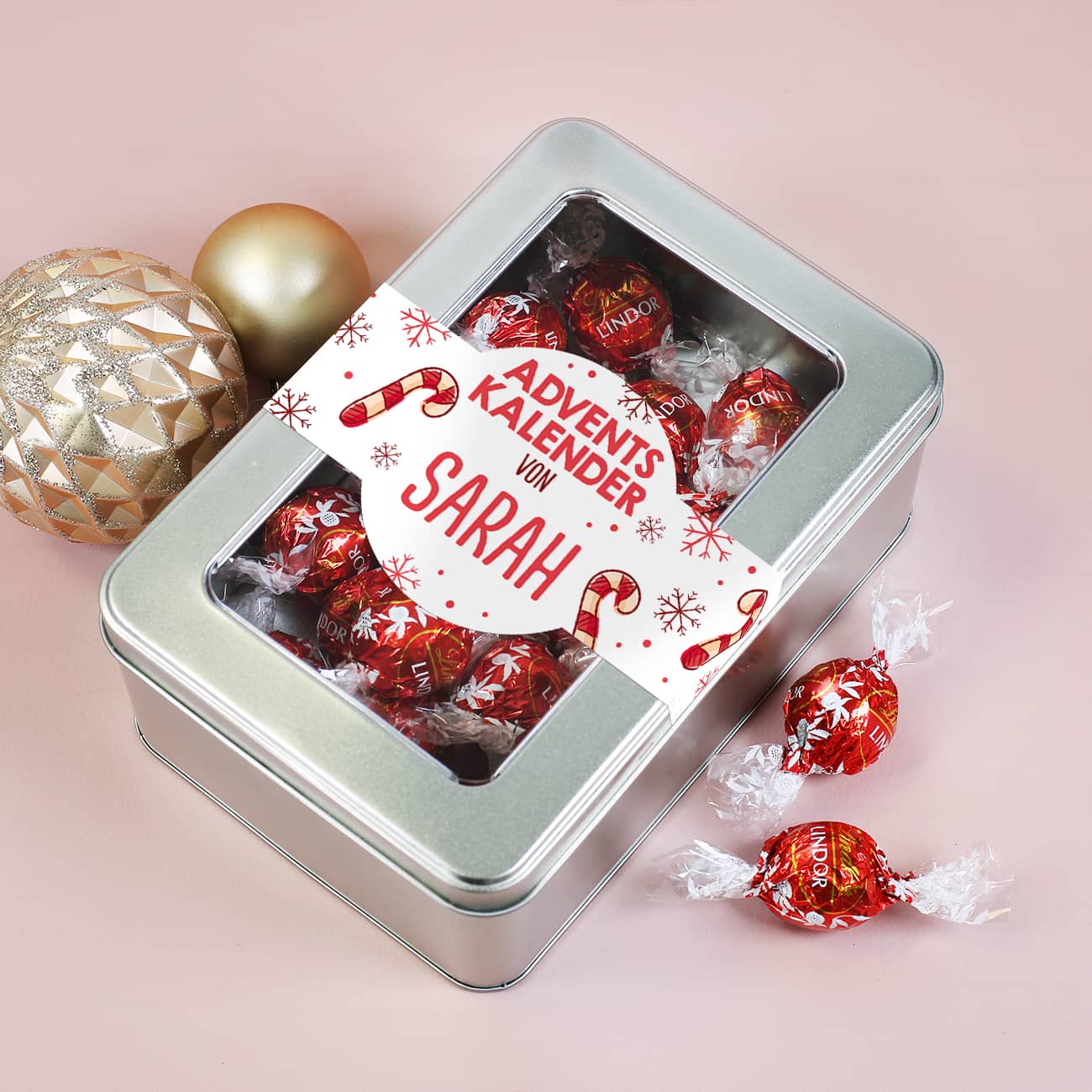 Adventskalender in Metalldose mit Sichtfenster gefüllt mit 24 Lindorkugeln