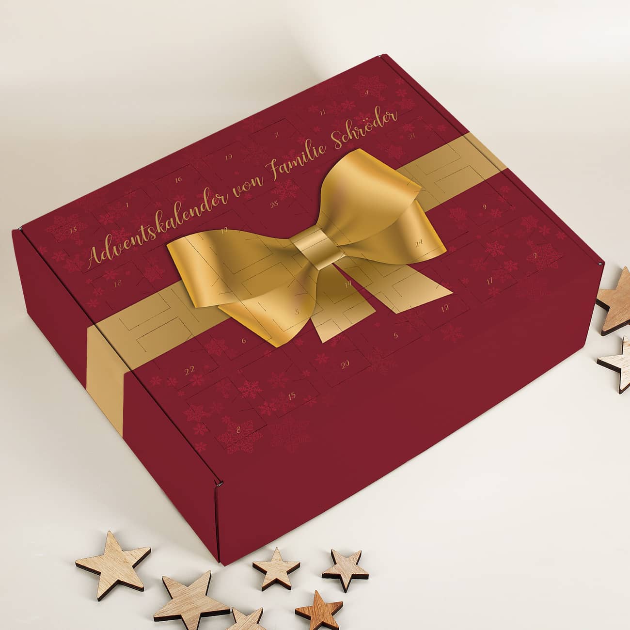Adventskalender in rot mit goldener Schleife