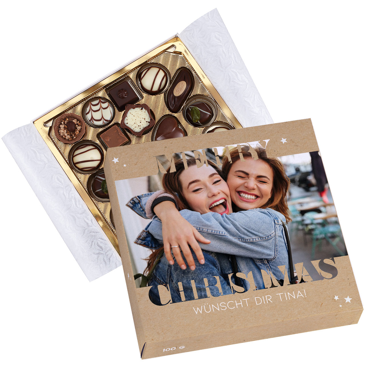 Geöffnete Lindt Pralinenbox Merry Christmas mit goldener Innenschale und personalisiertem Deckel.