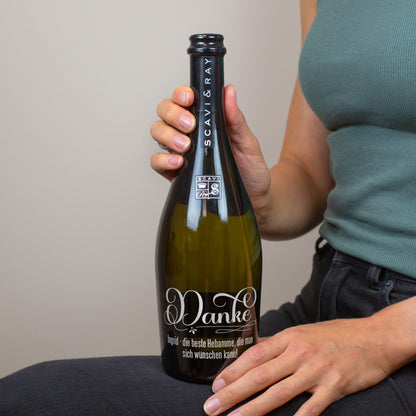 Person hält personalisierte Prosecco-Flasche mit Danke-Gravur und individuellem Text für eine Hebamme