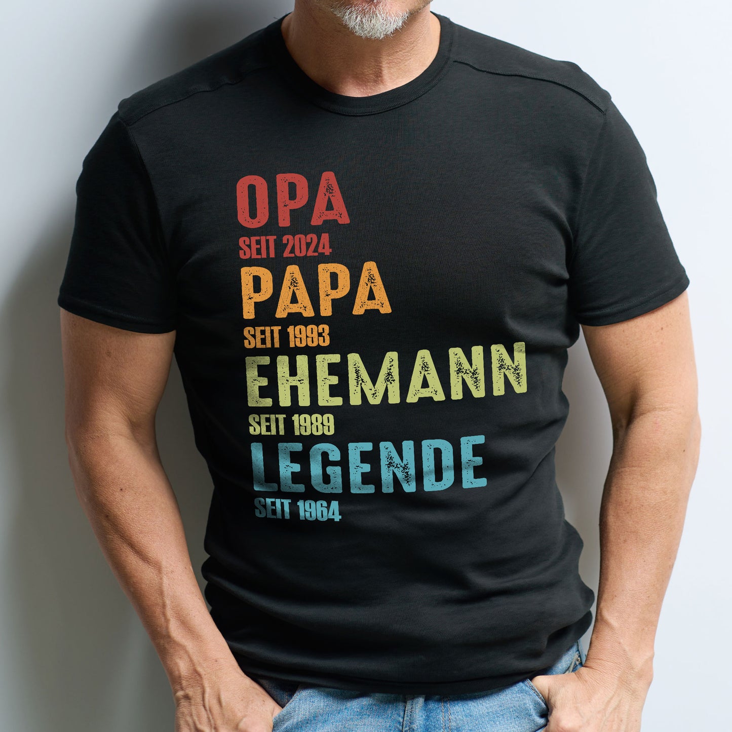 Mann mit Bart trägt das personalisierte T-Shirt – Schriftzug und Jahreszahlen in bunter Gestaltung gut lesbar.