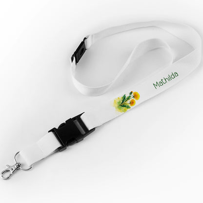 Schlüsselband mit dem Namen "Mathilda" und gelbem Löwenzahn-Design auf weißem Hintergrund